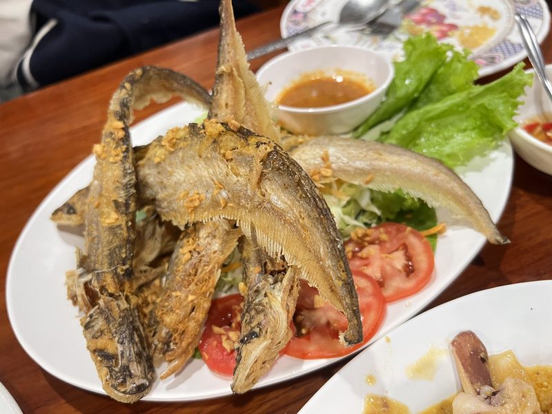ปลาเนื้ออ่อนทอดกระเทียม เสิร์ฟกับผักสลัดและมะเขือเทศ